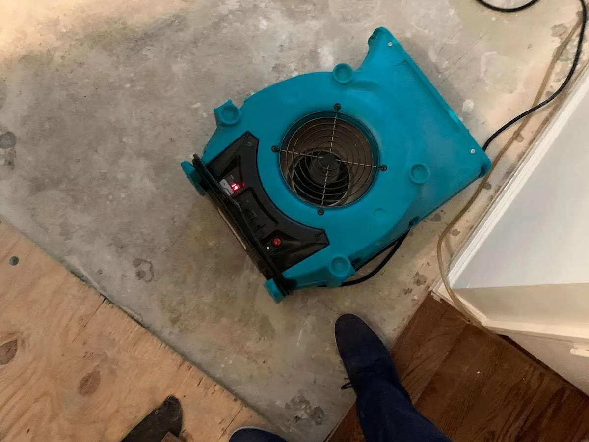 Air mover drying subfloor during Commercial Water Damage Restoration in Glencoe